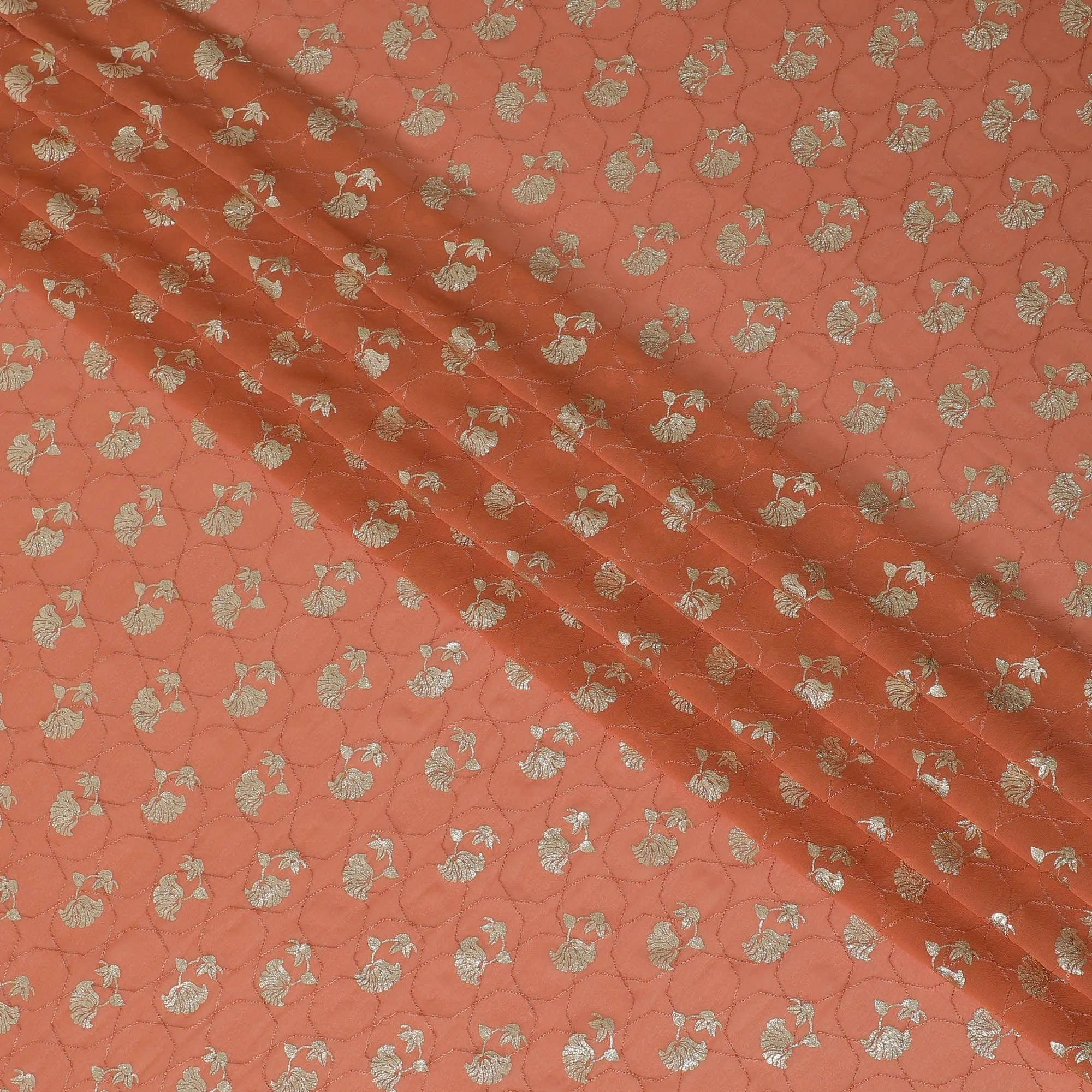 Creamsicle orange synthetic georgette fabric with same tone embroidery having gold foil print in floral design-D12032